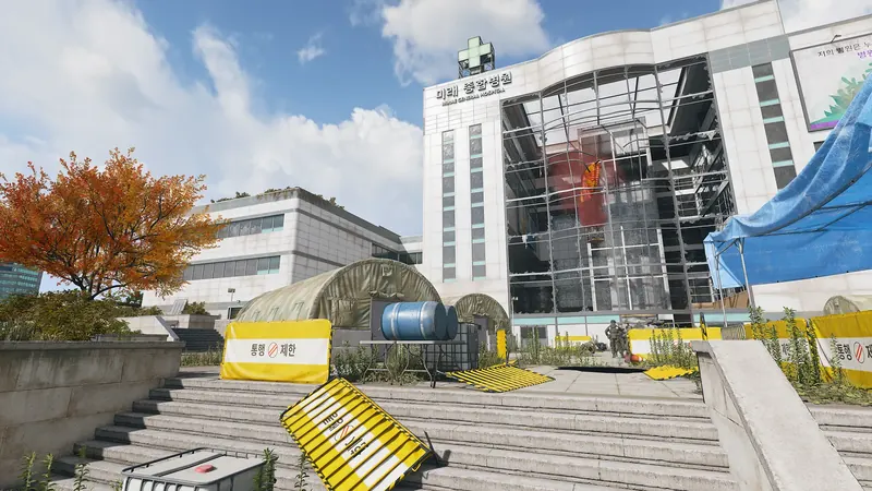 Mirae General Hospital entrance with shattered glass, emergency tents, yellow barricades, and armed soldiers.