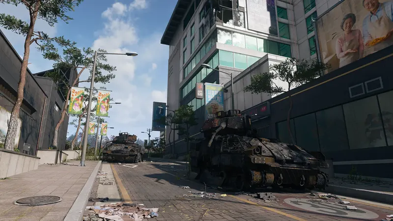 Two abandoned armored vehicles sit along a debris-covered city street lined with modern buildings and Korean banners.