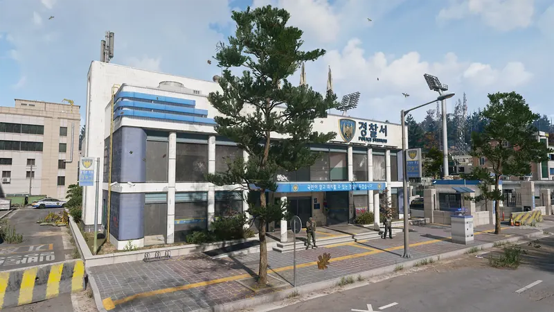 Two-story police station with blue trim, Korean signage, a large pine tree, and armed guards near the entrance.
